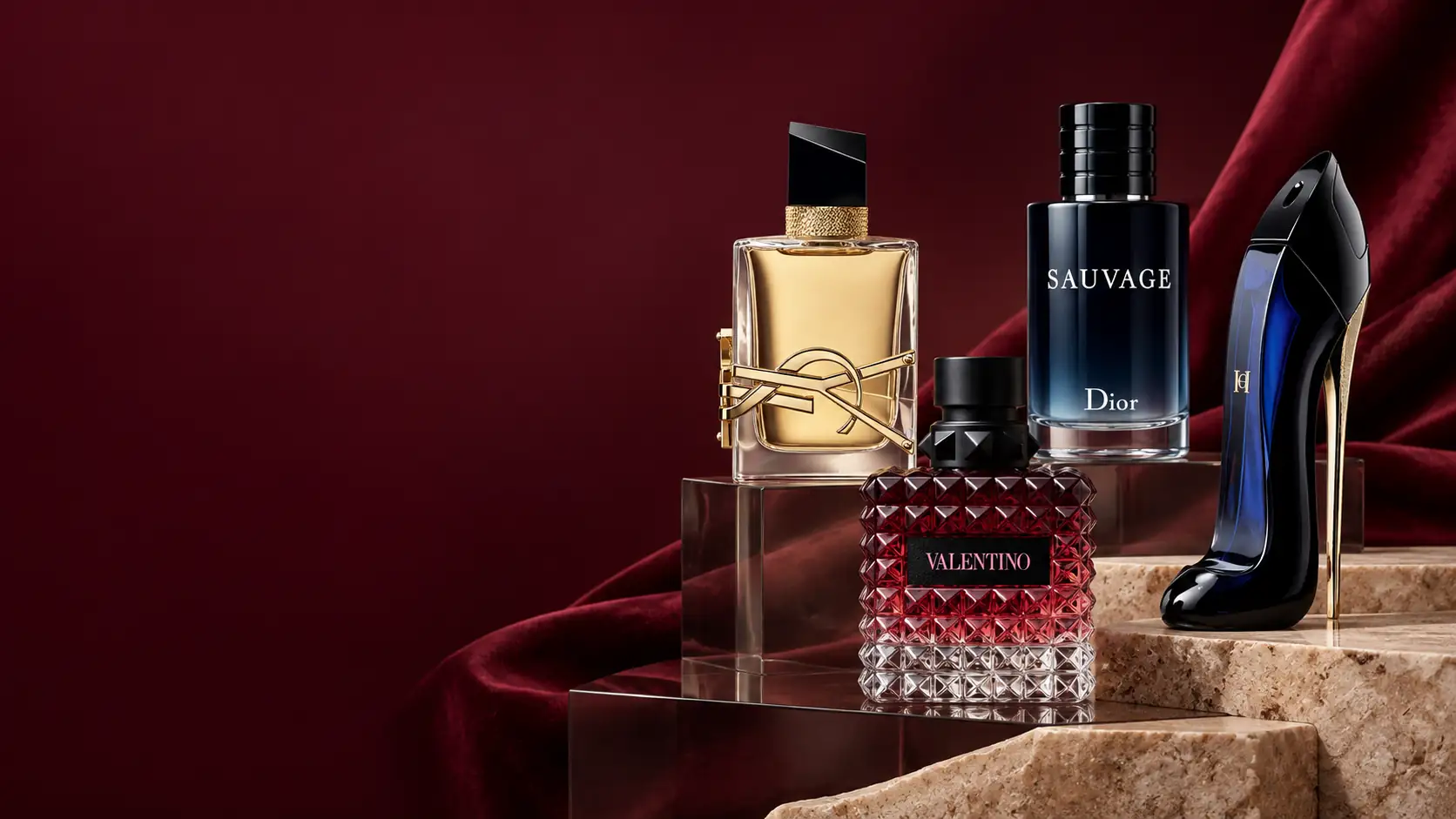A luxury perfume still life with 4 bottles on burgundy and cream display stands