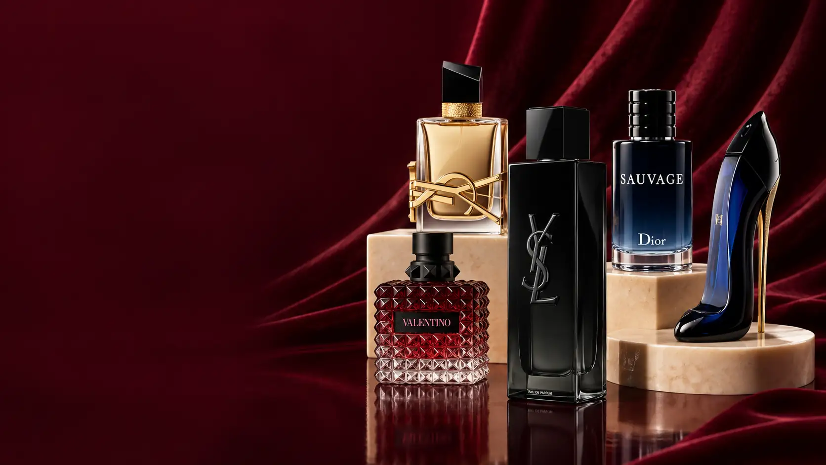 A luxury perfume still life with 5 bottles on burgundy and cream display stands